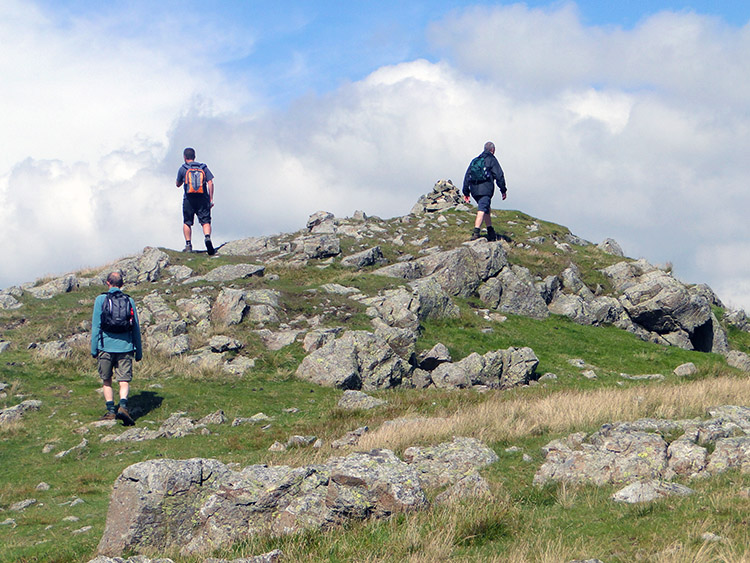 Scaling the short rocky path to Calfhow Pike