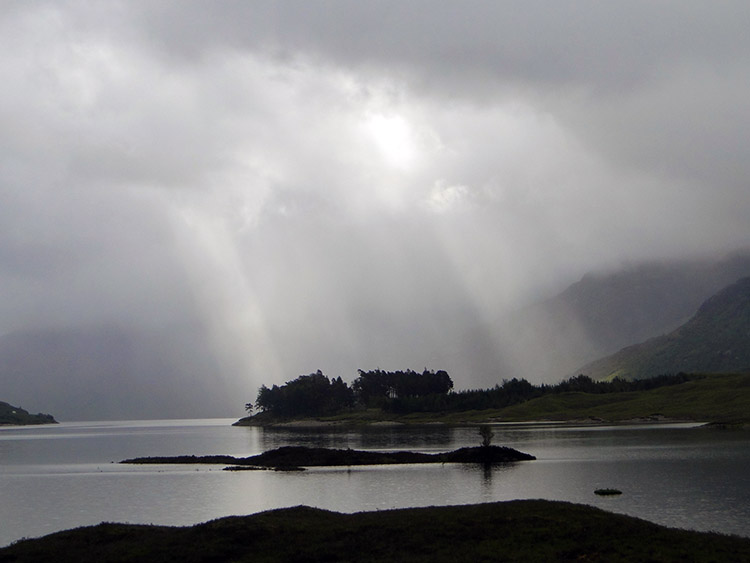 Sunlight piercing cloud over Loch Cluanie