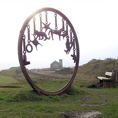 Coastal sculpture, old pump house and rail line to the mine